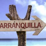 Barranquilla,wooden,sign,with,a,beach,on,background