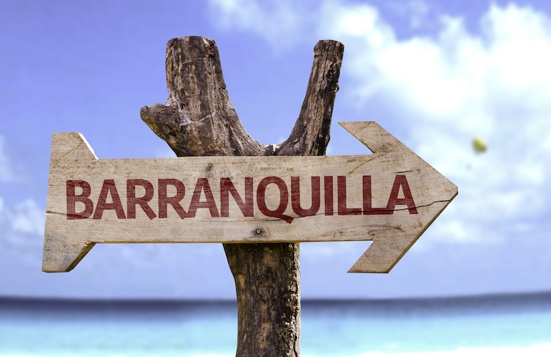 Barranquilla,wooden,sign,with,a,beach,on,background
