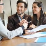 Attractive Couple Signing Sales Agreement With Real Estate Agent