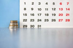 The Money On The Background Of The Calendar.the Concept Of Repayment Of A Loan,installment Plan,mortgage.debt Payment.