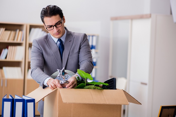 Man Moving Office With Box And His Belongings