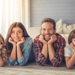 Parents And Their Children Are Looking At Camera.