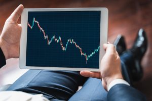 Businessman, Investor,trader Analyzing,looking At Chart Of Stock Prices In Tablet. Ceo,general Manager.bank Investment.finance Company,hedge Fund.japanese Candlestick,diagram