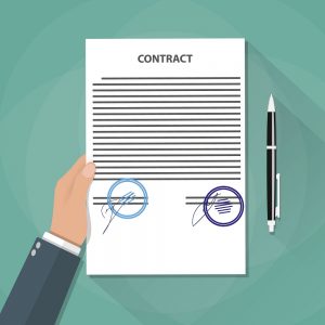 Hand Holds Contract Documents