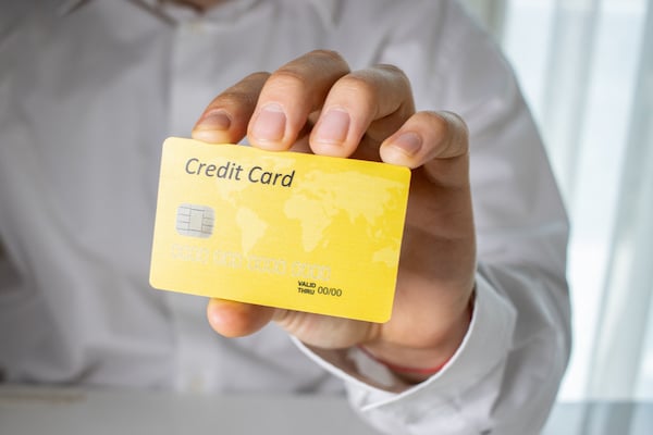 Person Holding Yellow Credit Card