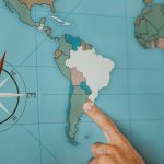 Person Pointing To South America On The Map