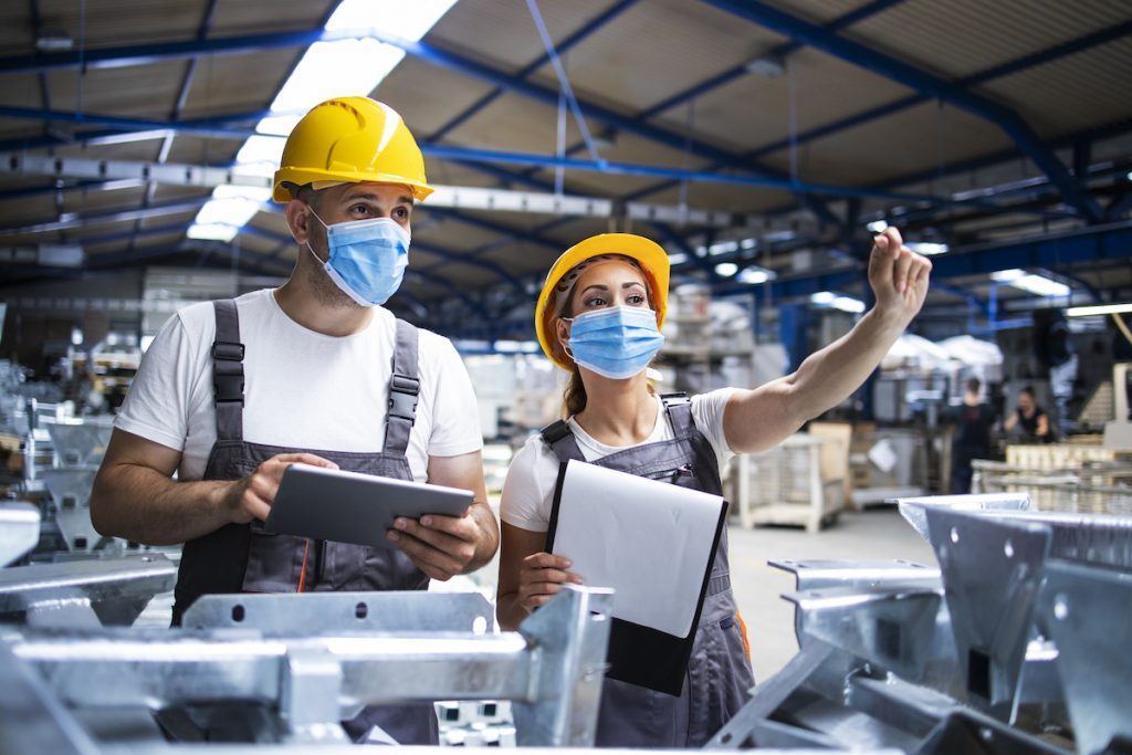 Factory Workers With Face Masks Protected Against Corona Virus