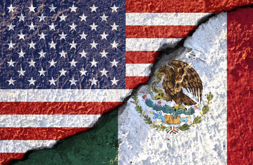 Usa Flag And Mexico Flag On Cracked Wall Damage.